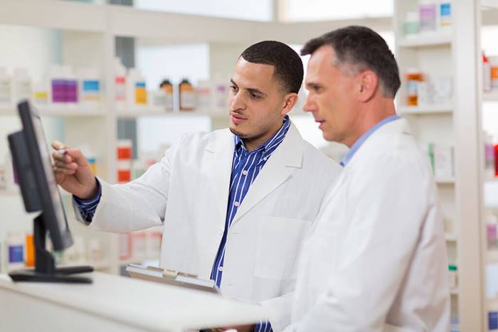 two pharmacists looking at computer