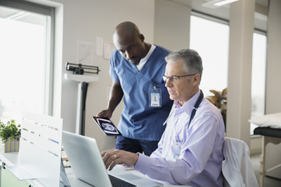 medical professionals reviewing information on computer