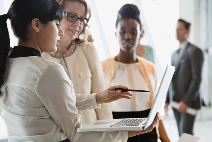 women reviewing notes on computer