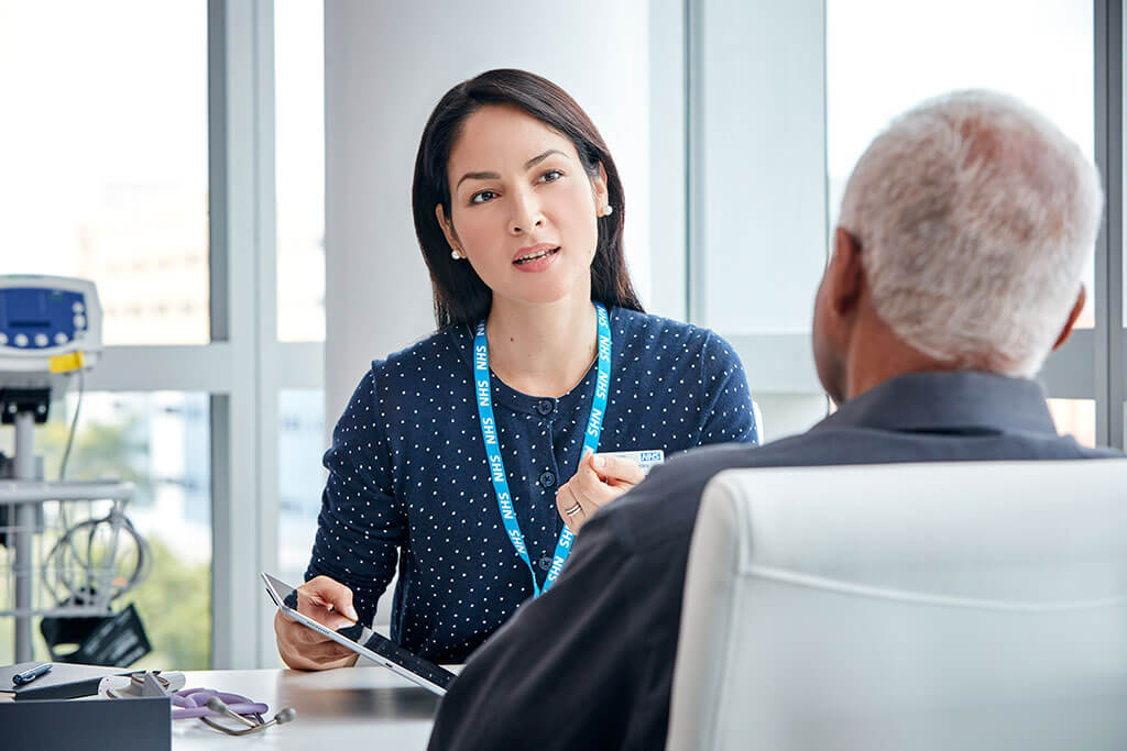 NHS doctor meeting with senior patient