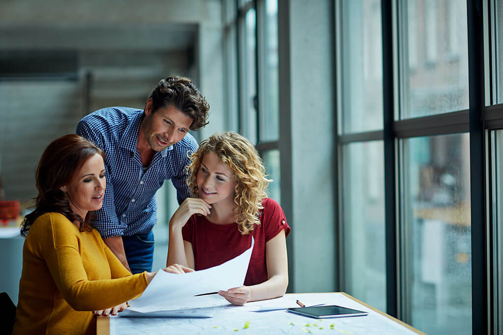 three people reviewing paper