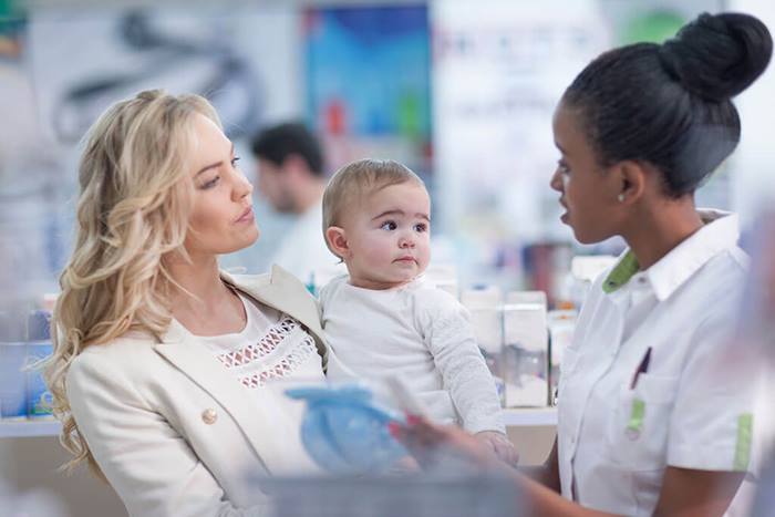 Mother with baby in a pharmacy