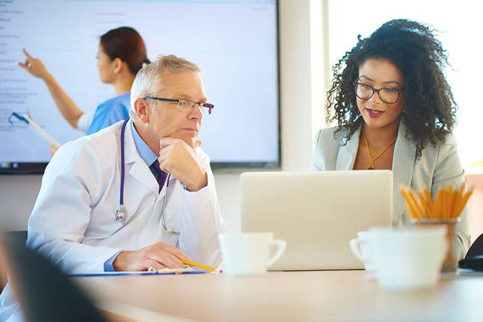 medical professionals looking at laptop