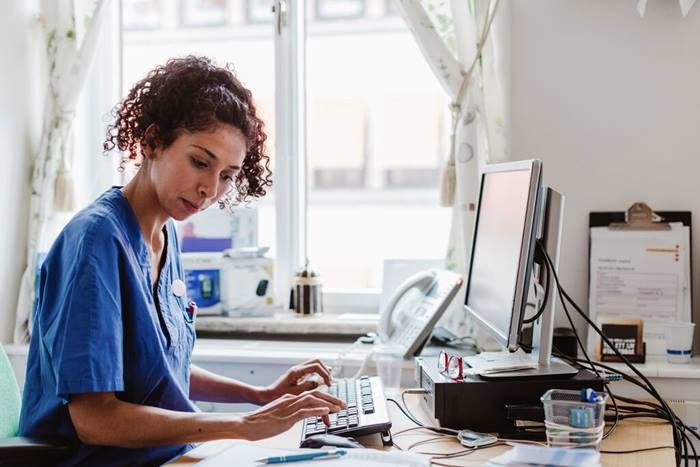 Nurse typing medical report