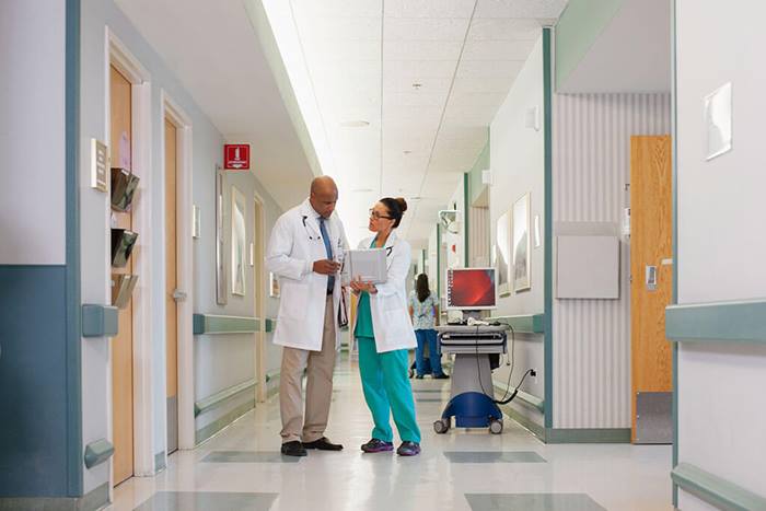 doctors reviewing patient information in hallway