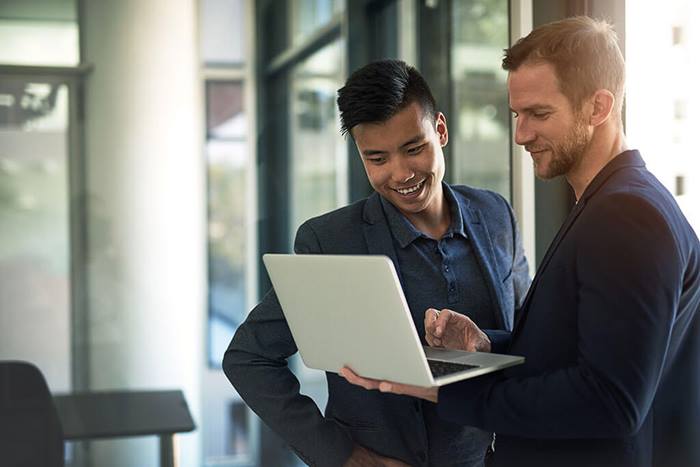 Businessmen looking at laptop