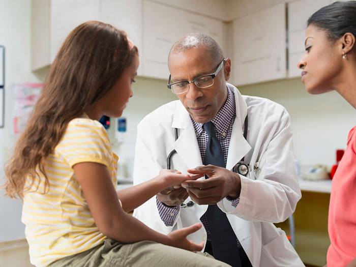 Pediatrician evaluating girl