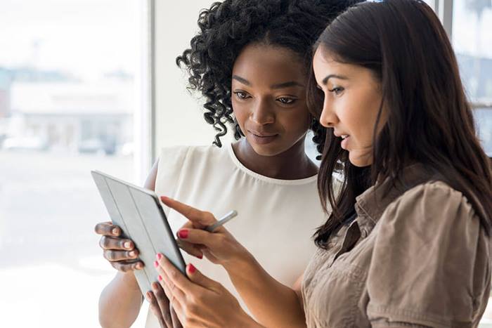 businesswomen looking at tablet