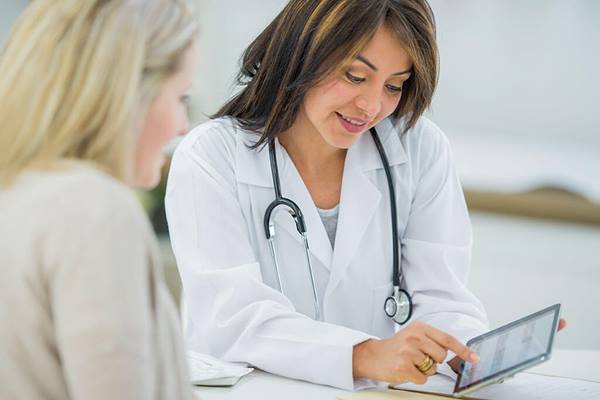 doctor sharing information on tablet with patient