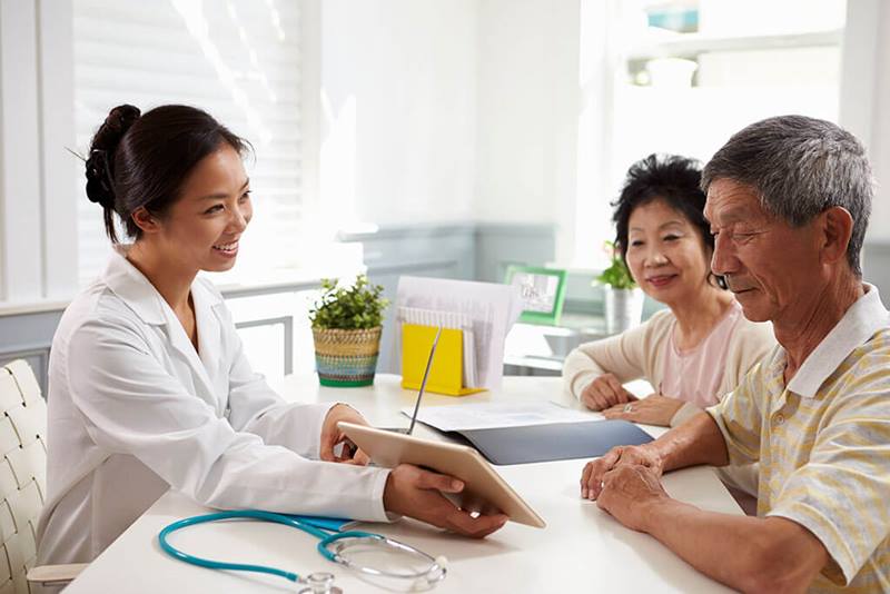 senior couple meeting with doctor