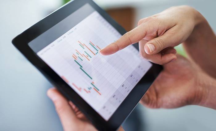 businesswoman pointing at tablet screen