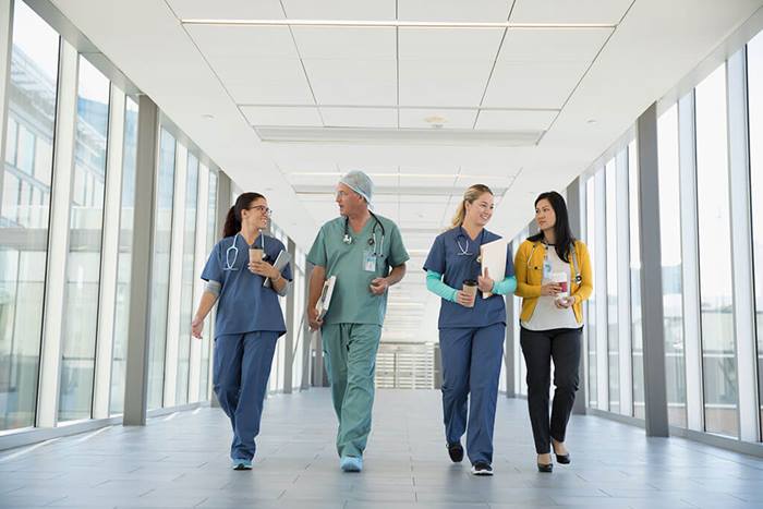 Healthcare staff talking and walking in hospital