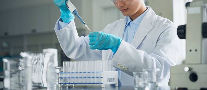 Man in a white coat experimenting in a laboratory