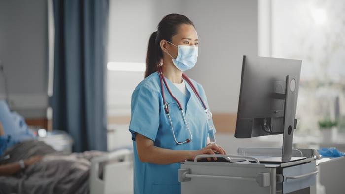 Head Nurse Wearing Face Mask Checking Patients Medical Data