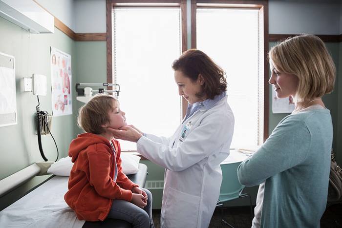 Pediatrician examining child patient