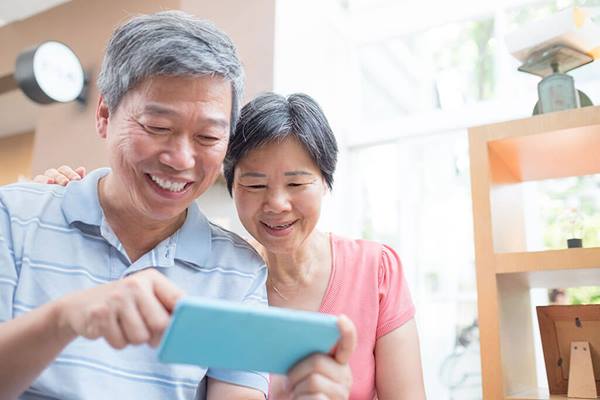 old couple look at smart phone