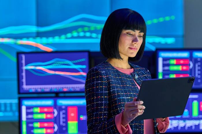 Photo of a woman reviewing data on tablet