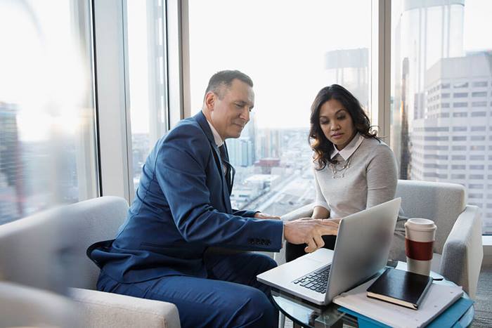 Professionals meeting around a laptop