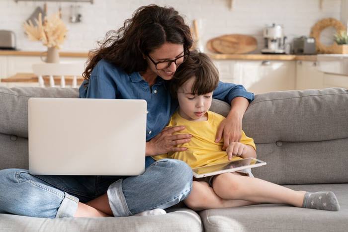 Mother using a tablet with her son