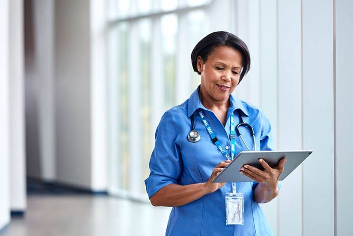 NHS professional looking at tablet