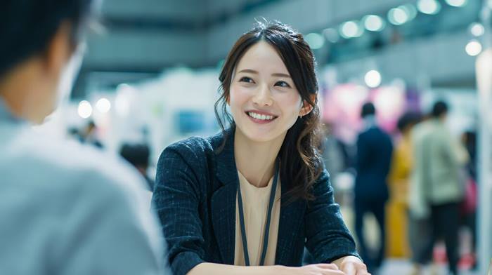 Smiling professional businesswoman at conference event