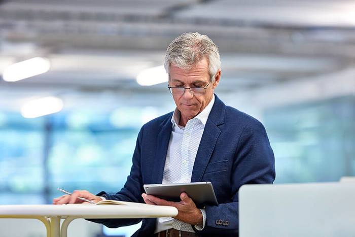 older male reviewing tablet