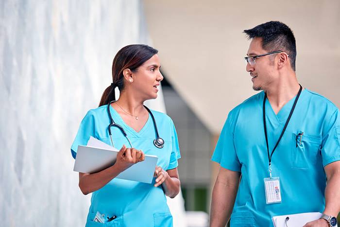 doctor and nurse walking and talking