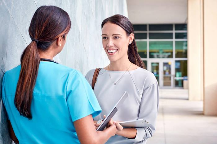 sales rep meeting with doctor outside