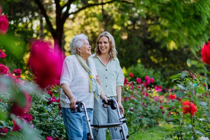 Woman walking with a senior lady in the park