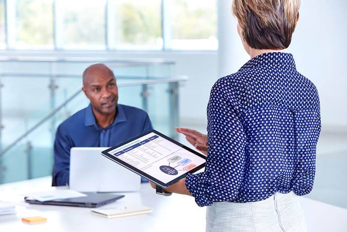female holding tablet and talking