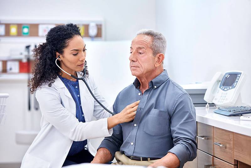 doctor checks patients breathing