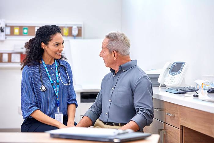 NHS doctor consulting patient