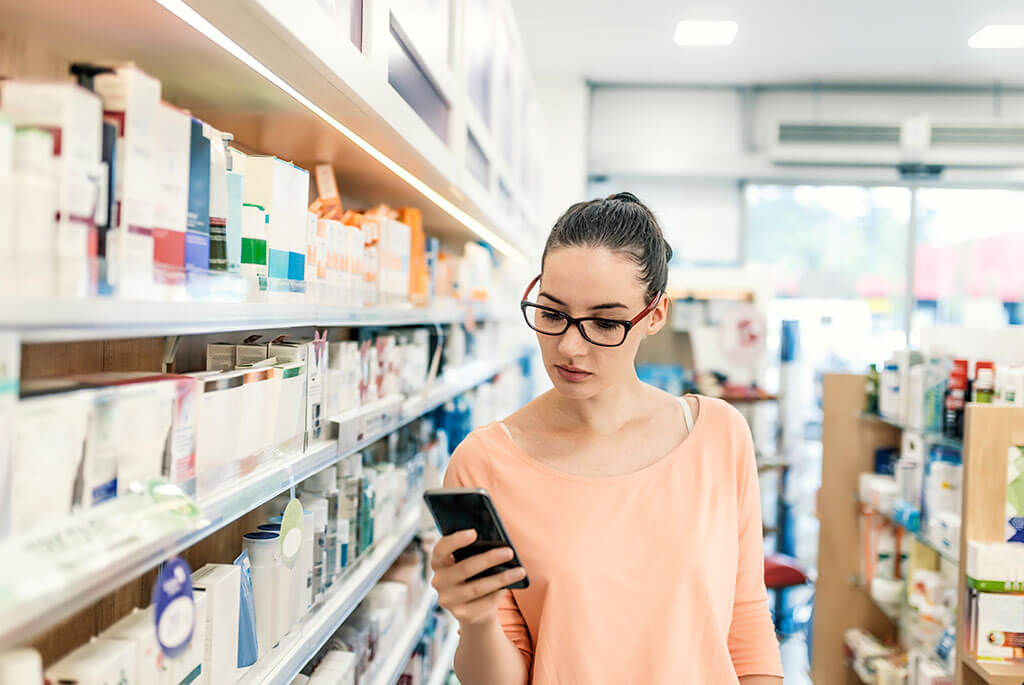 599_Consumer Health_Female in store looking at cellular device