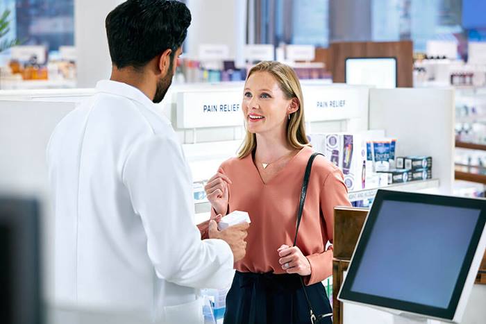 male pharmacist and female blonde customer smiling