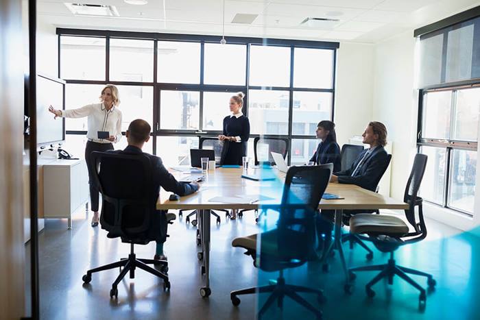 Businesswoman leading meeting in conference room