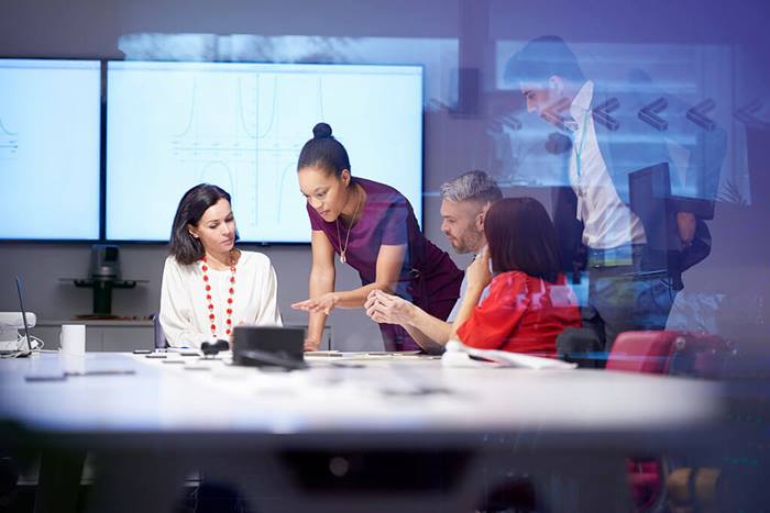 group of people looking at data during business meeting