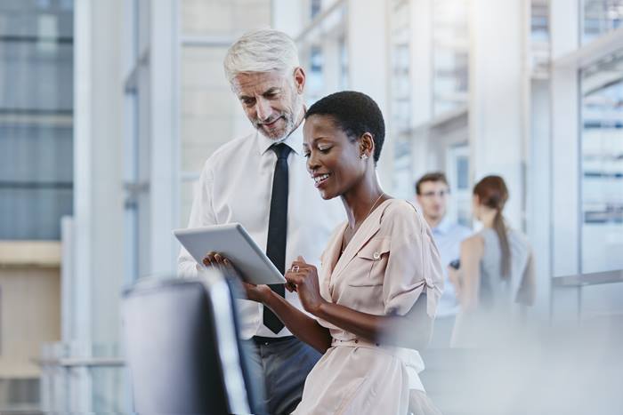 Businessman and Businesswoman looking at tablet